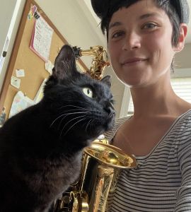 Alexandra with her cat and her alto saxophone
