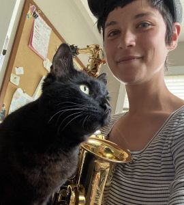 Alexandra with her cat and her alto saxophone