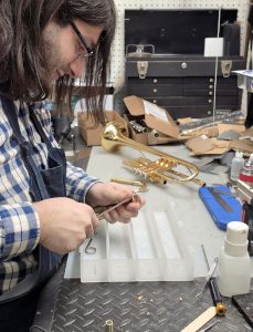 Arbor at work on a trumpet