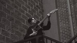 Cash, aiming his guitar